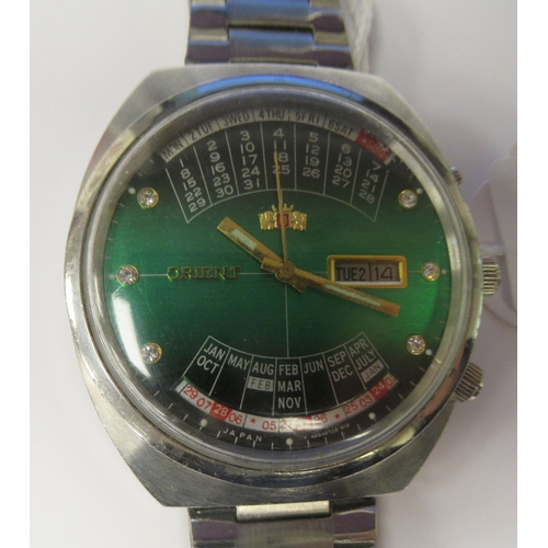 96 - A vintage Orient automatic perpetual, universal stainless steel cased bracelet watch, faced by a gre... 