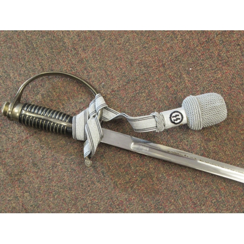 123 - A German SS dress sword with a silvered tassel, the blade 32.5