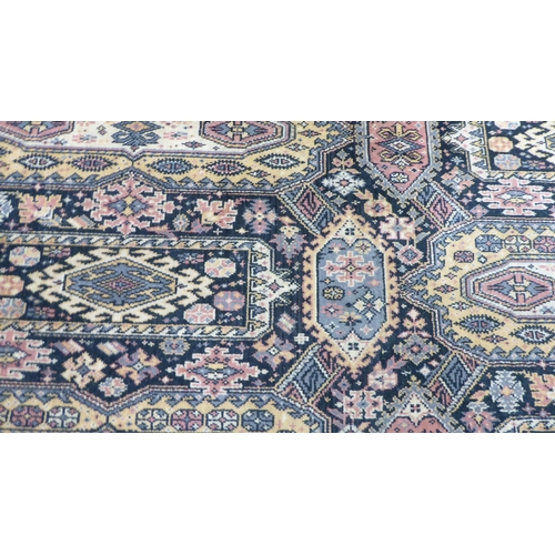 120 - An English made, Persian inspired carpet, decorated with repeating motifs, bordered by stylised desi... 