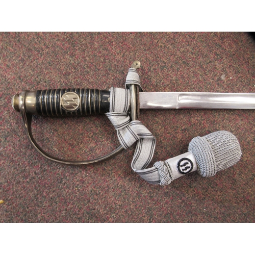 123 - A German SS dress sword with a silvered tassel, the blade 32.5