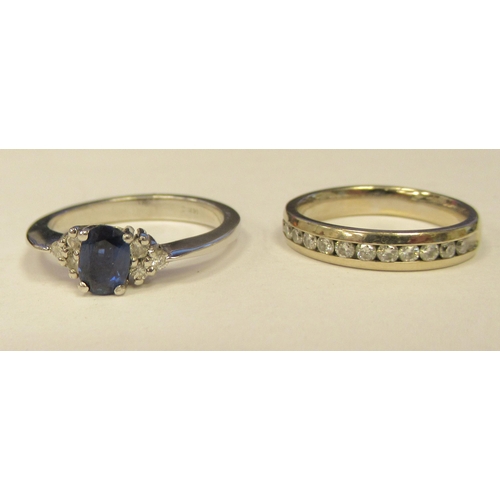 13 - A 14ct white gold diamond half eternity ring; and a 14ct white gold diamond and sapphire ring