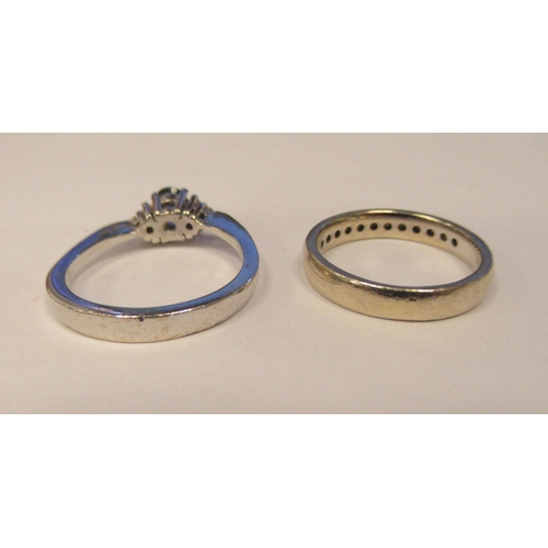 13 - A 14ct white gold diamond half eternity ring; and a 14ct white gold diamond and sapphire ring