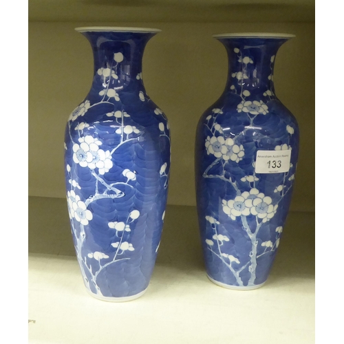 133 - A pair of late 19thC Chinese porcelain prunus pattern vases of baluster form  bearing four char... 