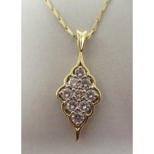 14 - A gold coloured metal nine stone set diamond pendant, on a fine twist wire link neckchain and ring&n... 