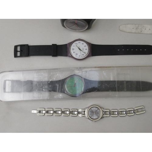 142 - Variously cased and strapped Swatch wristwatches