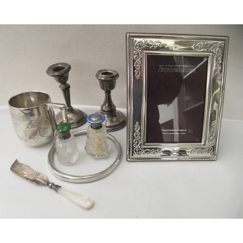 145 - Silver and white metal collectables: to include a beaker  stamped 800; and a silver photograph ... 