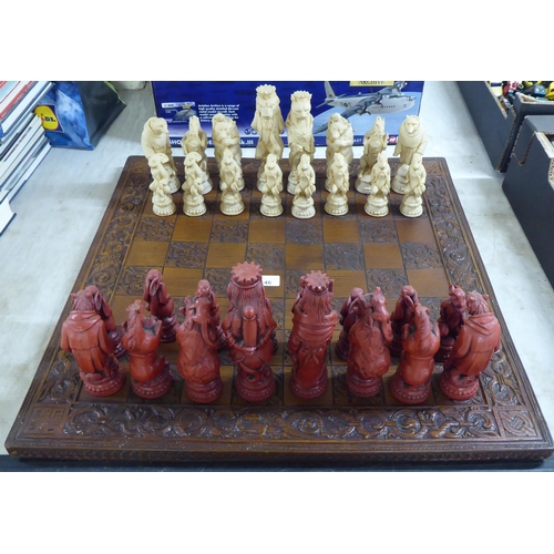 146 - A novelty resin chess set, the board 23.5