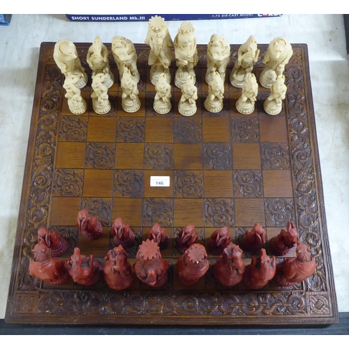 146 - A novelty resin chess set, the board 23.5