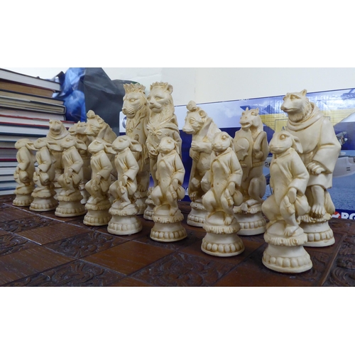 146 - A novelty resin chess set, the board 23.5