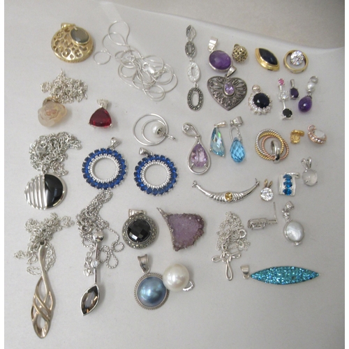 174 - Costume jewellery: to include white metal pendants and earrings 