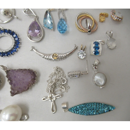 174 - Costume jewellery: to include white metal pendants and earrings 