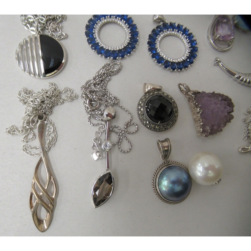 174 - Costume jewellery: to include white metal pendants and earrings 