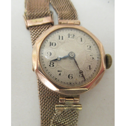 185 - A ladies 9ct gold cased wristwatch, on a wide flexible bracelet, faced by an Arabic dial 