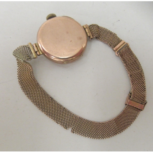 185 - A ladies 9ct gold cased wristwatch, on a wide flexible bracelet, faced by an Arabic dial 