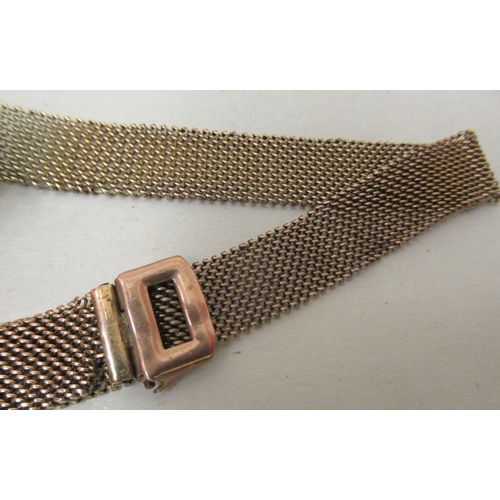 185 - A ladies 9ct gold cased wristwatch, on a wide flexible bracelet, faced by an Arabic dial 