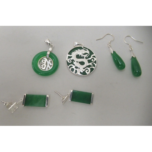 205 - Modern Oriental jade and white metal mounted jewellery, comprising two pairs of earrings and two dis... 