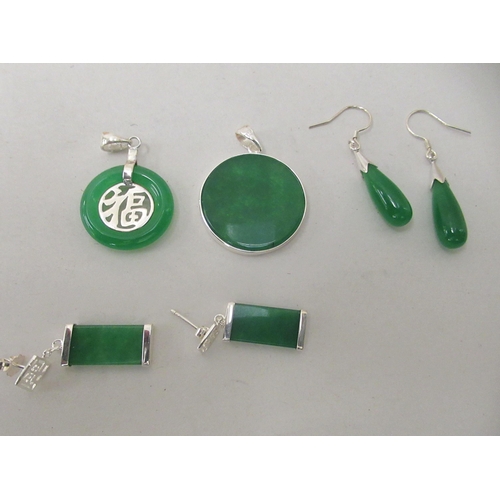 205 - Modern Oriental jade and white metal mounted jewellery, comprising two pairs of earrings and two dis... 