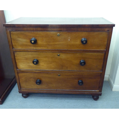 212 - A late 19thC mahogany three drawer dressing chest with bun handles, raised on turned feet  35