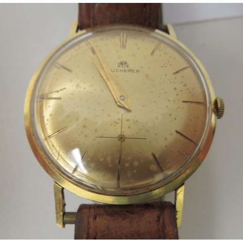 215 - A vintage Bucherer yellow metal cased wristwatch, faced by a baton dial, incorporating a subsidiary,... 