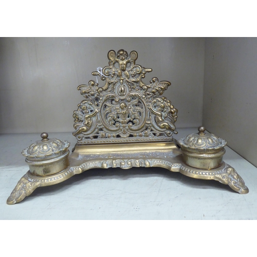 220 - A Victorian style brass deskstand, incorporating a letter rack, a pen channel and a pair of inkwell ... 