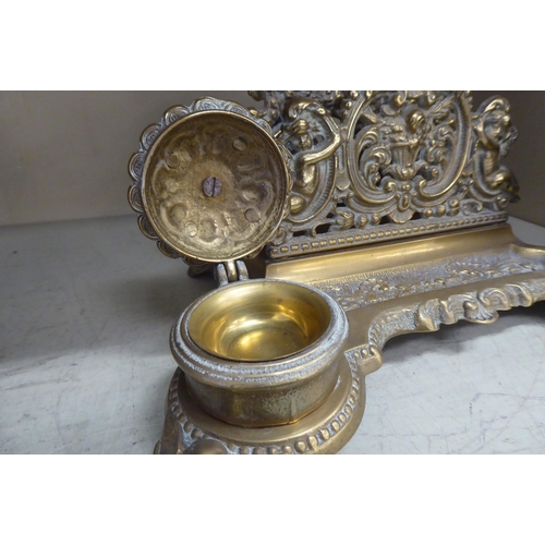 220 - A Victorian style brass deskstand, incorporating a letter rack, a pen channel and a pair of inkwell ... 