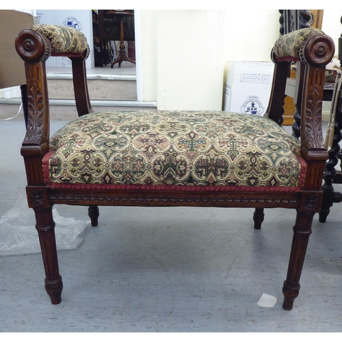 225 - A late Victorian carved mahogany framed window seat, upholstered in tapestry fabric, raised on turne... 