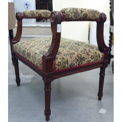 225 - A late Victorian carved mahogany framed window seat, upholstered in tapestry fabric, raised on turne... 