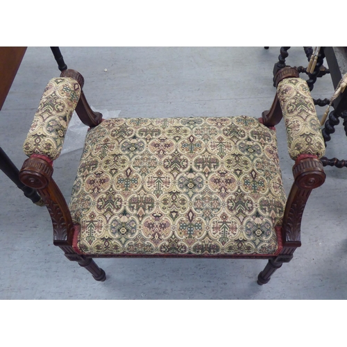 225 - A late Victorian carved mahogany framed window seat, upholstered in tapestry fabric, raised on turne... 