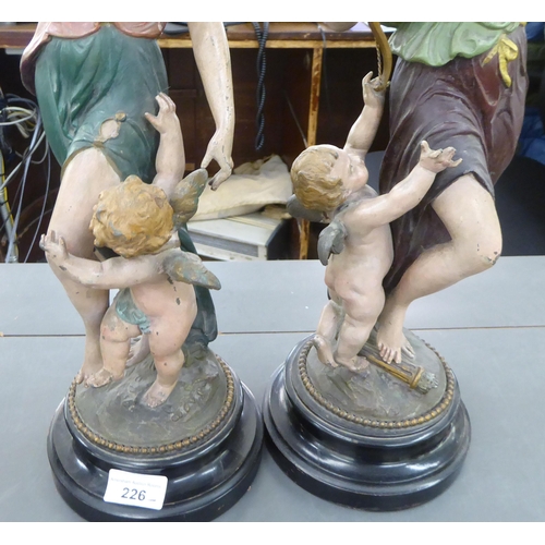 226 - A pair of late 19thC painted spelter female dancing figures, each on an ebonised plinth  19