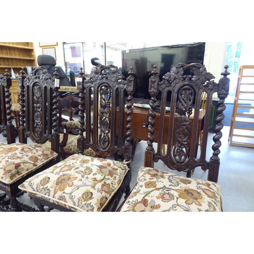 230 - A set of six early 20thC stained and carved oak framed dining chairs with trailing vine splats and b... 