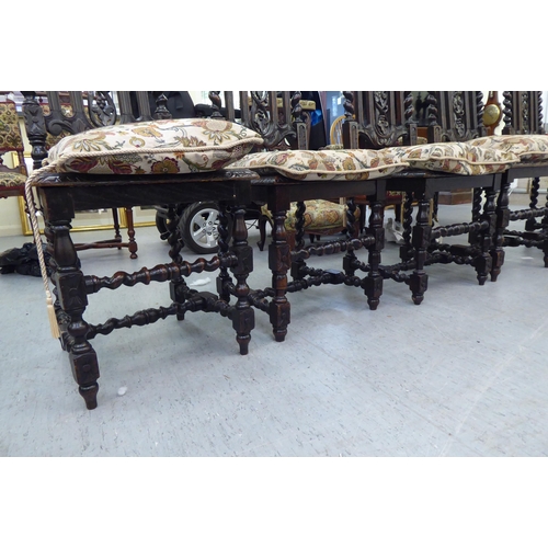 230 - A set of six early 20thC stained and carved oak framed dining chairs with trailing vine splats and b... 