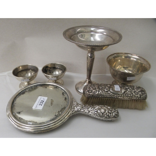 232 - Silver and white metal collectables: to include a dressing table hand mirror, elaborately decorated ... 