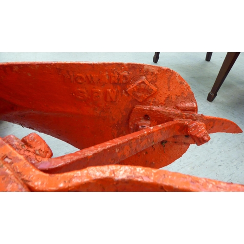 249 - An early 20thC Howard red painted steel horse drawn plough, on iron spoked wheels  120