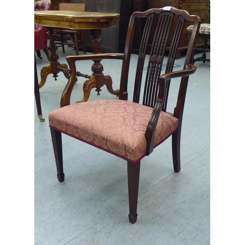 250 - A lady's Edwardian mahogany framed chair with decoratively carved splats and open arms, the braided,... 