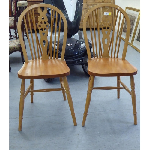 255 - A pair of modern light stained beech framed, hoop and wheelback Windsor breakfast room chairs with s... 