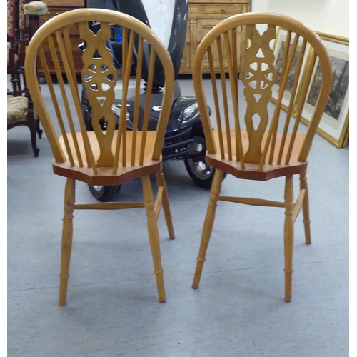 255 - A pair of modern light stained beech framed, hoop and wheelback Windsor breakfast room chairs with s... 