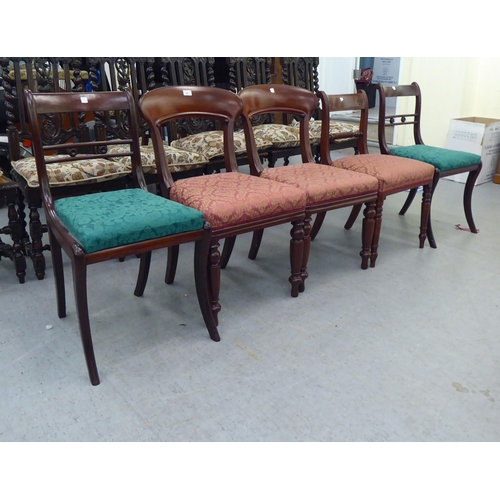 261 - A pair of late Regency design mahogany framed dining chairs with drop-in seats, raised on sabre legs... 