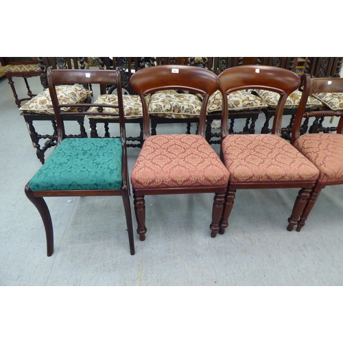 261 - A pair of late Regency design mahogany framed dining chairs with drop-in seats, raised on sabre legs... 