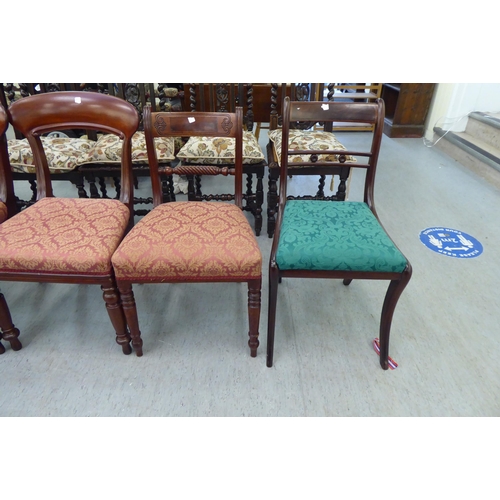 261 - A pair of late Regency design mahogany framed dining chairs with drop-in seats, raised on sabre legs... 