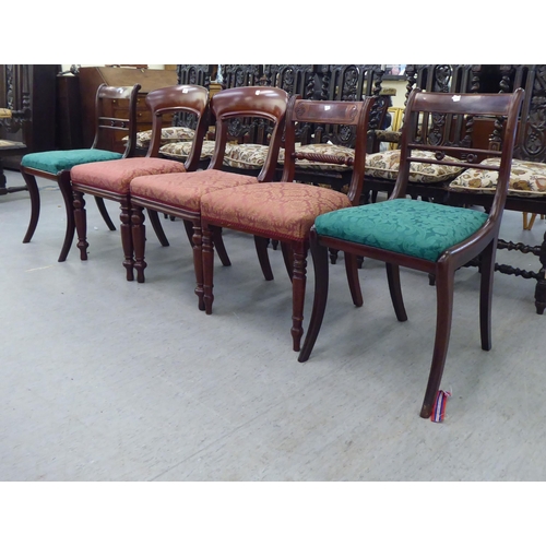 261 - A pair of late Regency design mahogany framed dining chairs with drop-in seats, raised on sabre legs... 