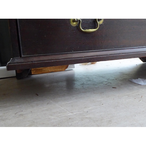 27 - A 19thC oak dressing chest, comprising two short/three long drawers with brass bail handles, raised ... 