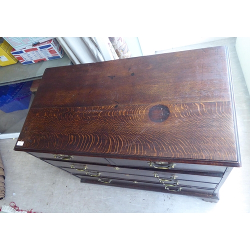 27 - A 19thC oak dressing chest, comprising two short/three long drawers with brass bail handles, raised ... 