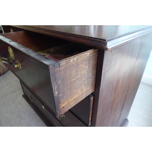 27 - A 19thC oak dressing chest, comprising two short/three long drawers with brass bail handles, raised ... 