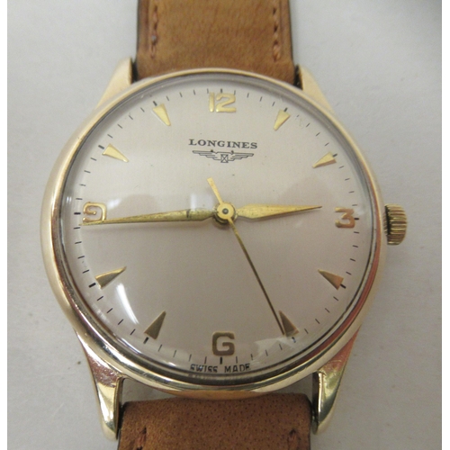 284 - A 9ct gold cased Longines manual wristwatch, faced by an Arabic dial, on a tan leather strap