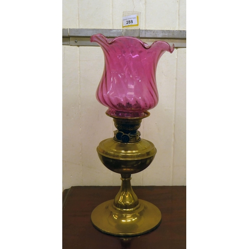 288 - An early 20thC oil lamp, the brass reservoir on an integral stand  13