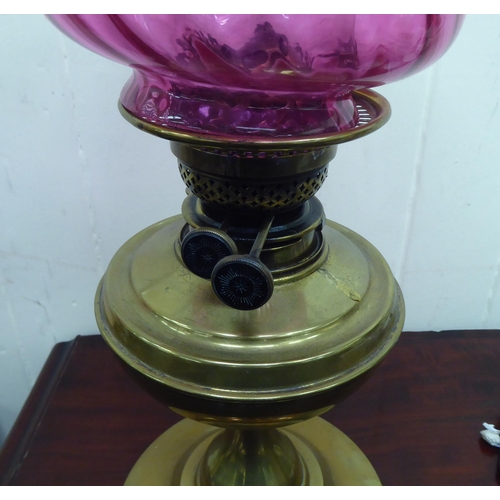 288 - An early 20thC oil lamp, the brass reservoir on an integral stand  13