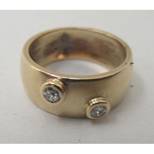 294 - A 9ct gold band, set with two diamonds