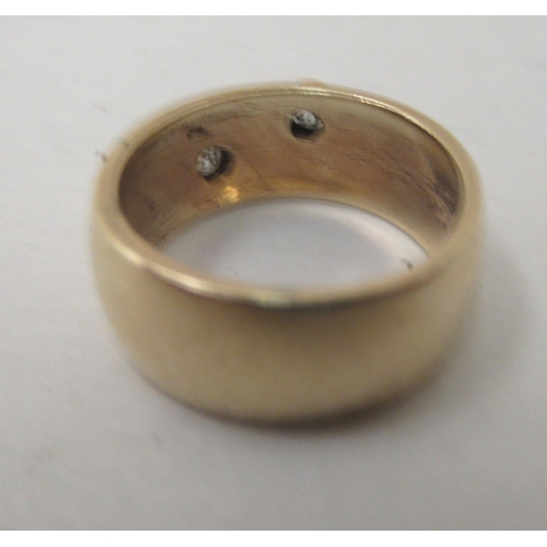 294 - A 9ct gold band, set with two diamonds