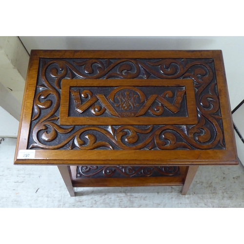 297 - A late 19thC mahogany two tier occasional table with foliate scrolled and ribbon carved ornament, ra... 