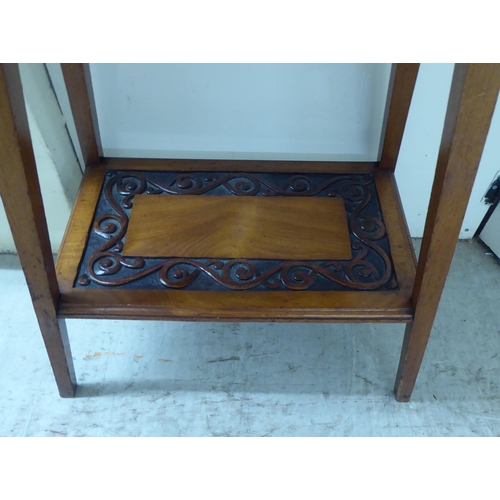 297 - A late 19thC mahogany two tier occasional table with foliate scrolled and ribbon carved ornament, ra... 